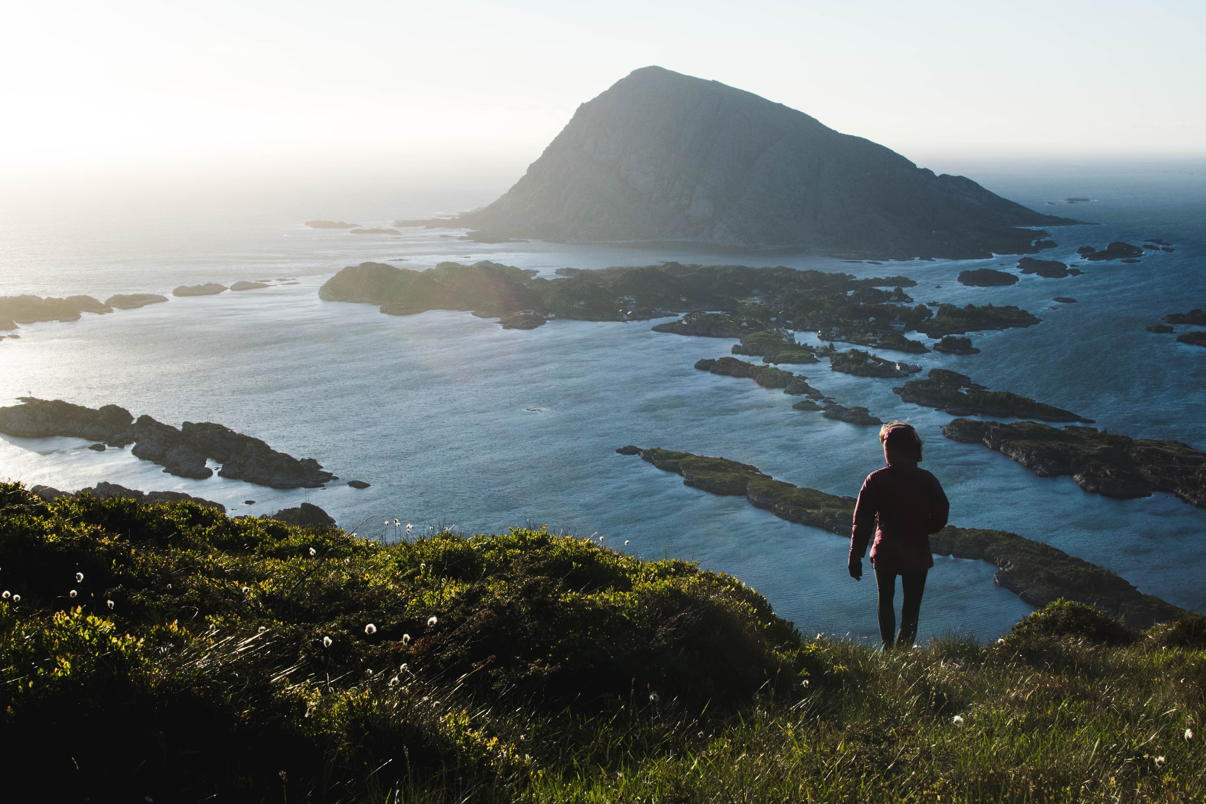 Kvinne på vei ned fra Blåkollen, med øygruppen Batalden i bakgrunnen